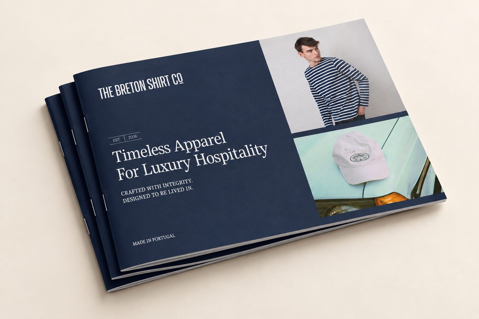 Stack of Breton Shirt Co brochures on a cream surface